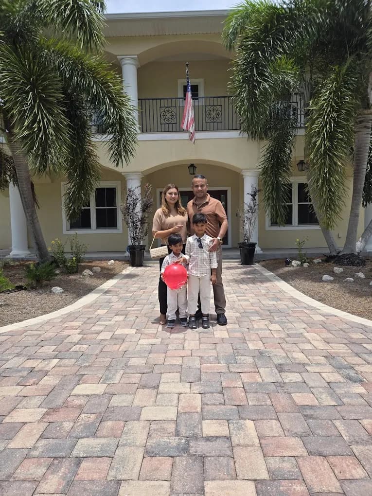 Family standing in front of their new home